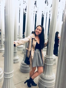 Woman standing in between LACMA light exhibit